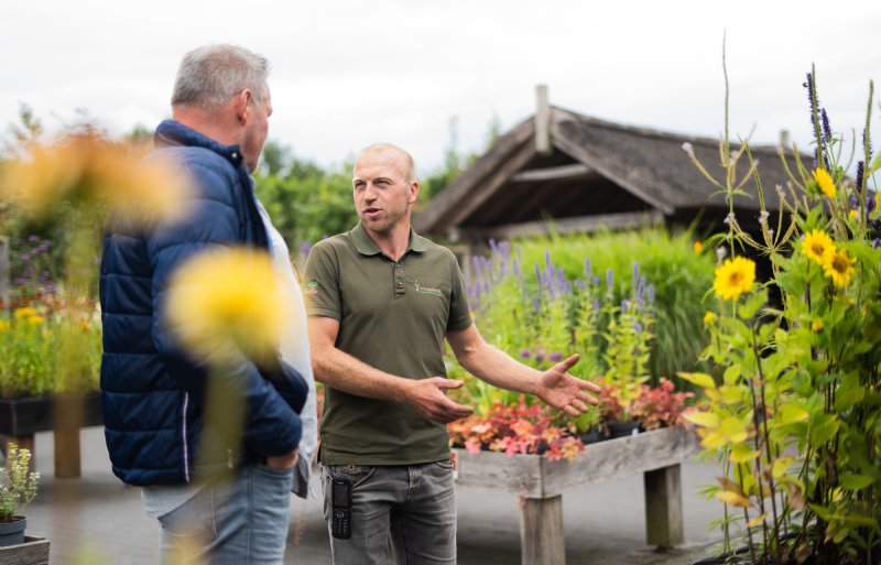 Frank Vreugdenhil leidt bezoekers rond op zijn tuinplantenkwekerij.